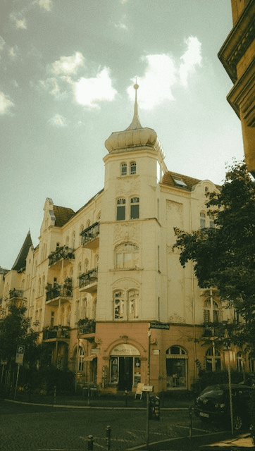 German historic corner building with turret, Art Nouveau detailing and terracotta roof